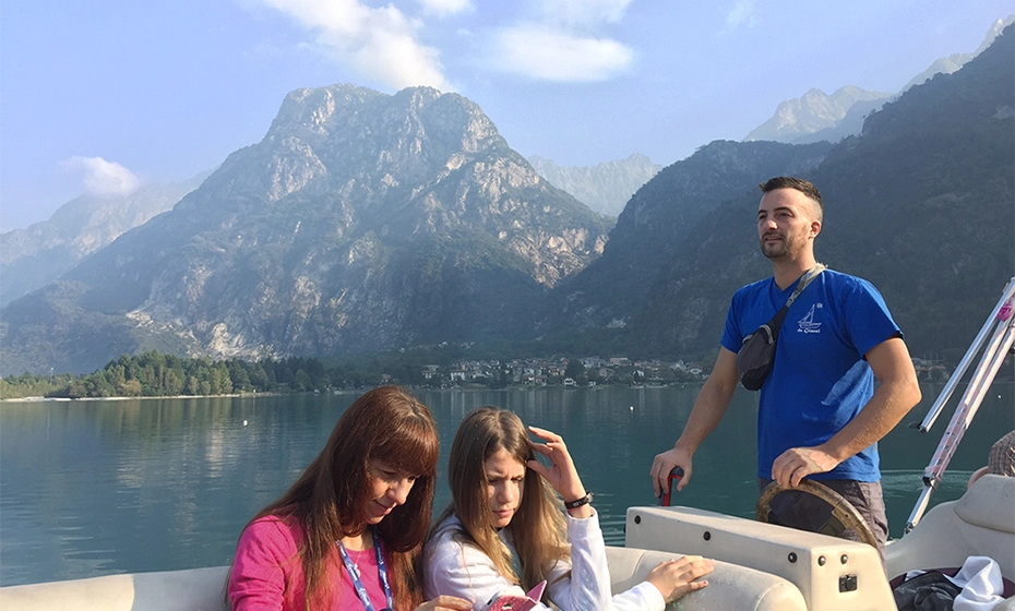 people boat lake mountains