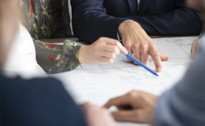 hands indicating sheets drawings project